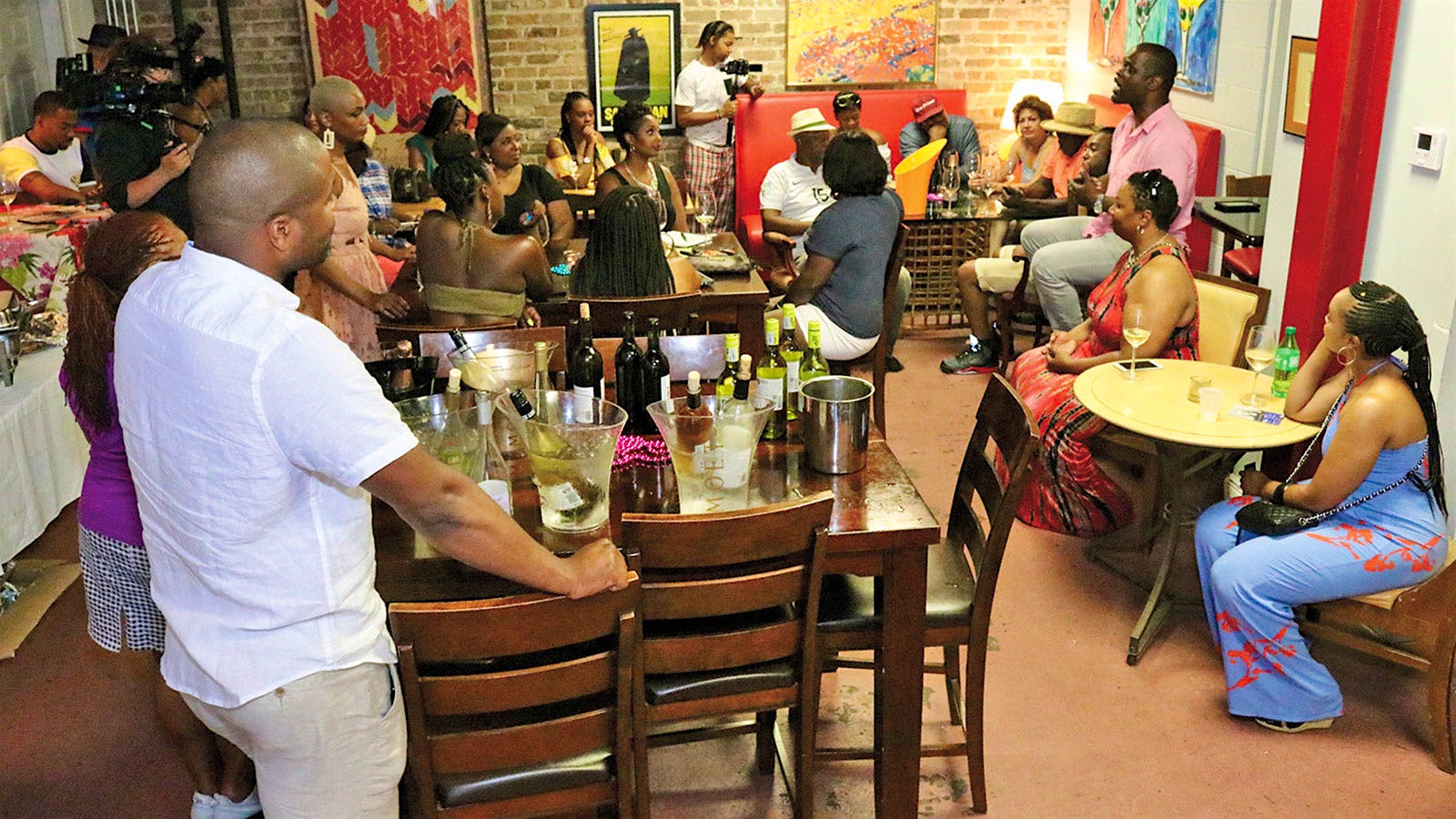 A group of Black wine lovers enjoying a wine tasting in a restaurant as part of the Hue Society’s Black Wine Experience at Essence Festival, 2019