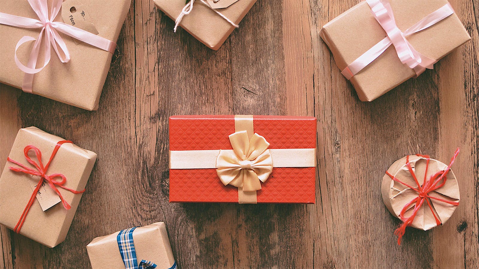 Wrapped holiday gift boxes on a wood table