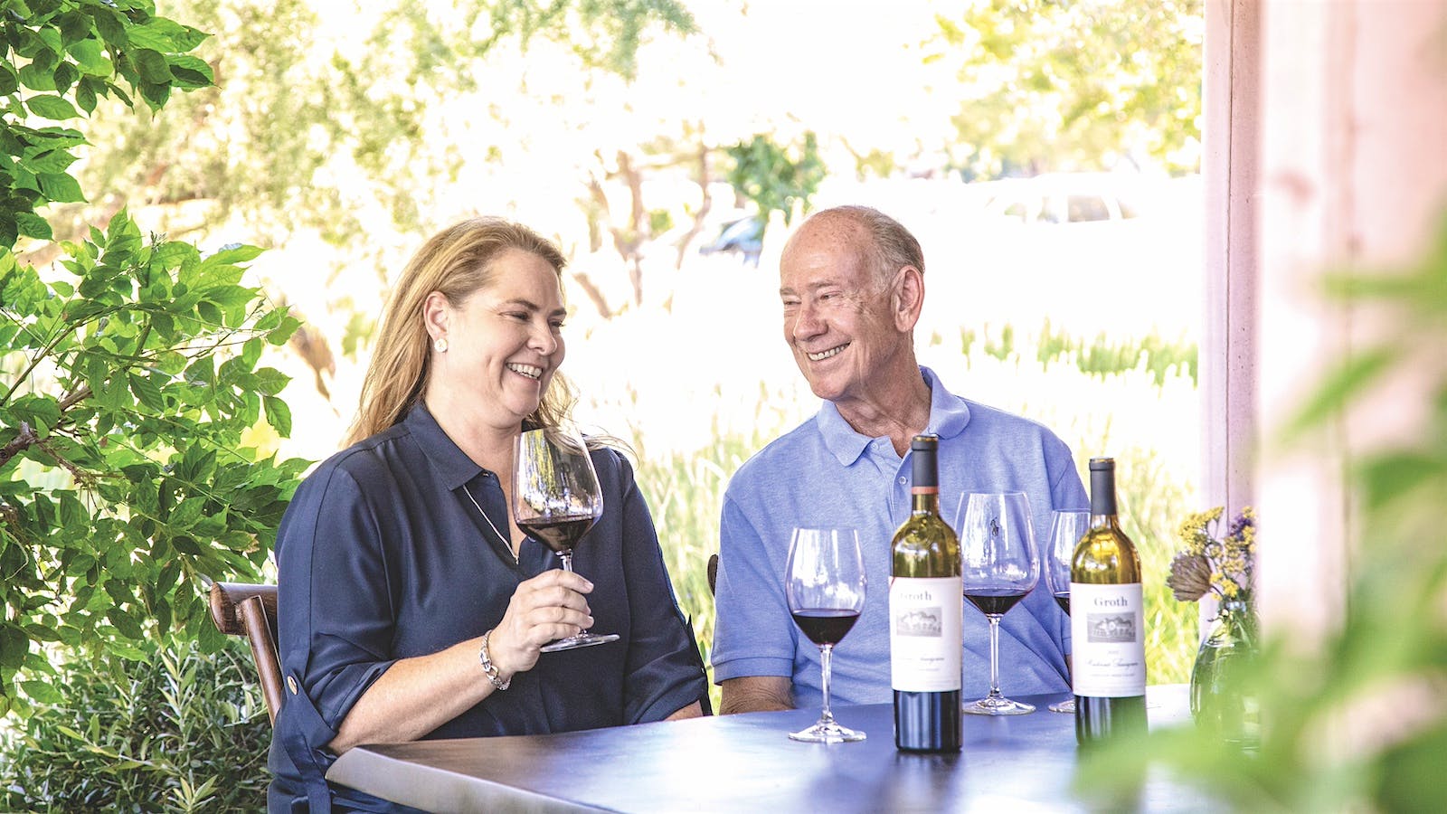 Suzanne and Dennis Groth sit together at their Napa family winery and taste glasses of Groth Cabernet Sauvignon.