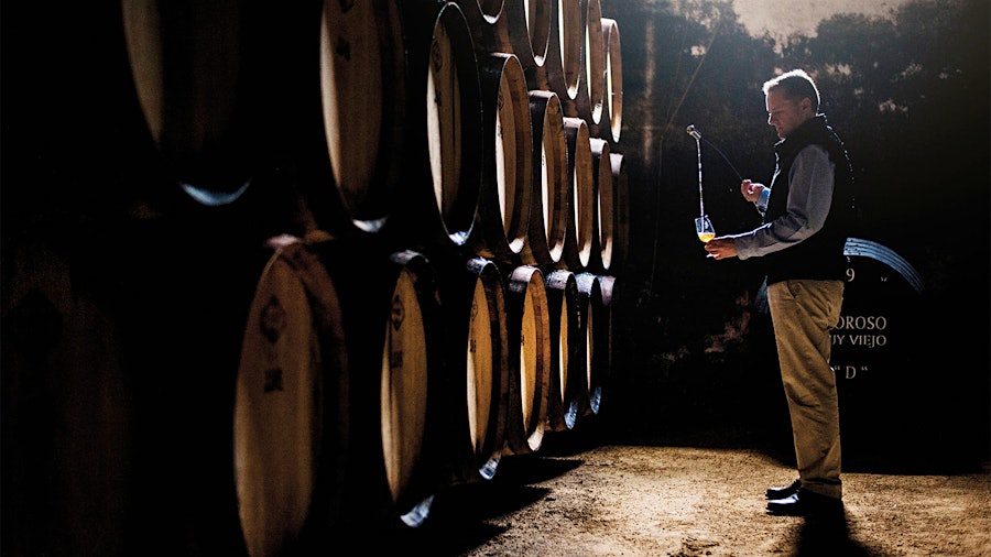 Sergio Martínez, winemaker at Bodegas Lustau in Jerez, draws Sherry from the solera aging system of barrels.