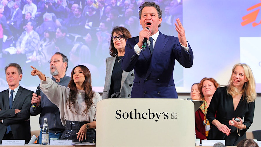 Left to right, Jean Reno (left, with microphone), Eva Longoria,  Zabou Breitman and Dominic West (at the podium), joined auction officials onstage to stoke the crowd during bidding on the auction’s top lot.