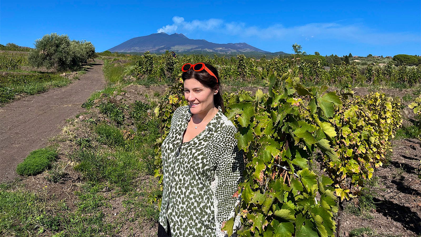 Gaia Gaja in one of Idda's vineyards, with Mount Etna smoking in the background